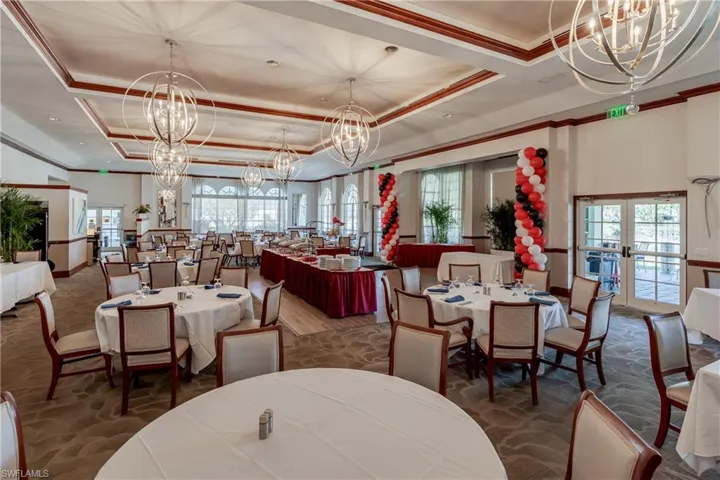 Dining area with hanging lights, french doors, plenty of natural light, ornamental molding, and a tray ceiling