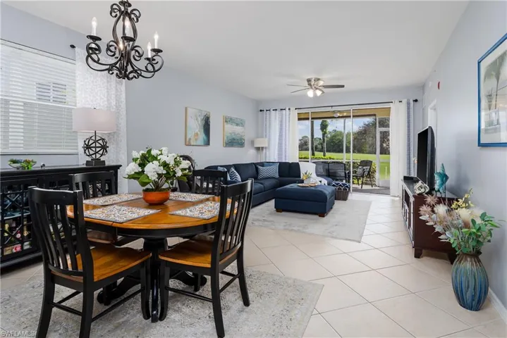 Dining area with healthy amount of natural light, ceiling fan, light tile patterned flooring, and hanging lights
