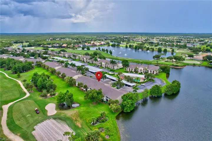 Birds eye view of property with a water view