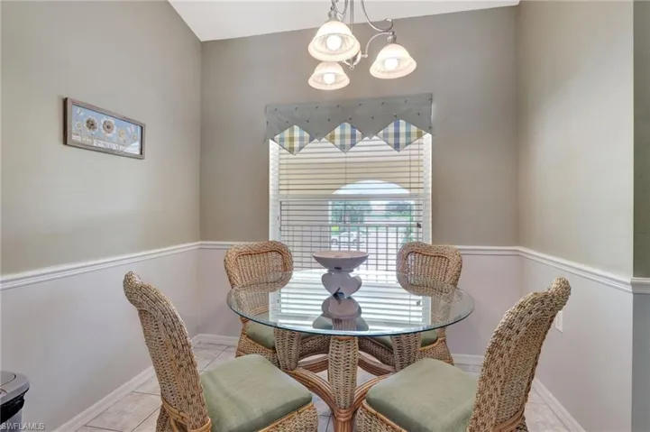 Tiled dining space with a chandelier