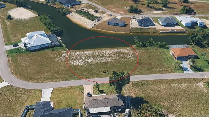 Aerial view of residential area featuring a nearby body of water