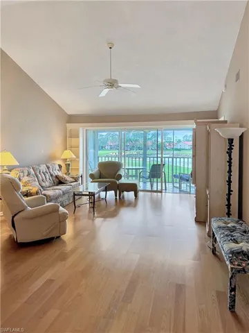 Living room with ceiling fan, a wealth of natural light, and light hardwood / wood-style flooring