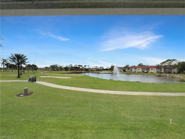 View of home's community with a water view and a lawn