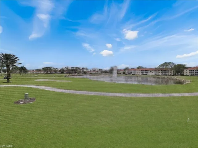 View of community featuring a water view and a lawn
