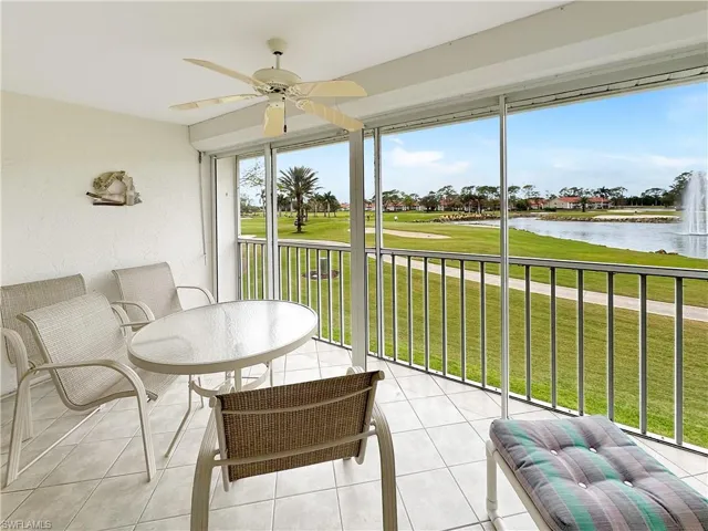 Sunroom featuring a water view and ceiling fan