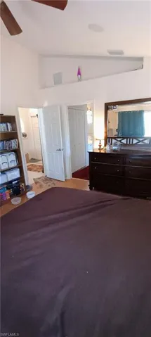 Bedroom with lofted ceiling, a closet, and ceiling fan
