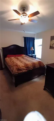 Bedroom with carpet flooring and ceiling fan