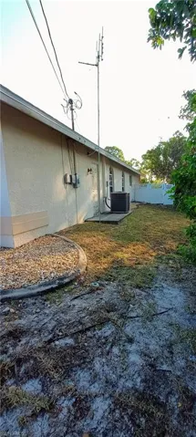 View of side of home featuring stucco siding and a patio
