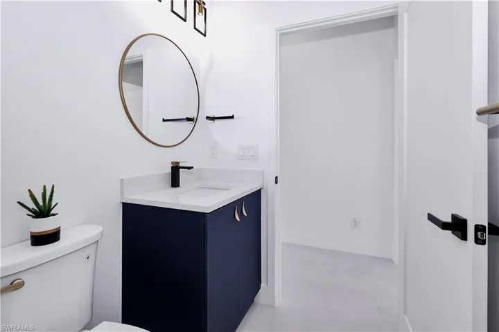 Bathroom with tile patterned flooring, vanity, and toilet