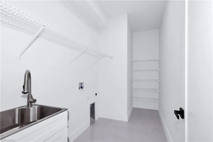 Washroom featuring washer hookup, sink, and hookup for an electric dryer
