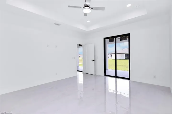 Spare room featuring ceiling fan and a raised ceiling