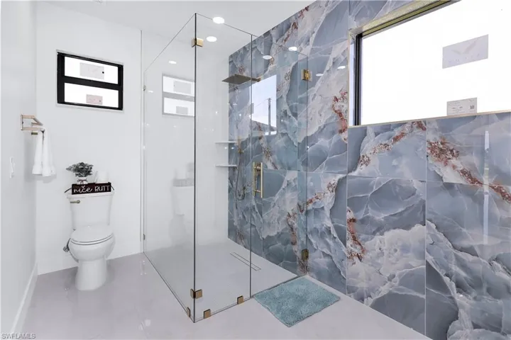 Bathroom featuring toilet and an enclosed shower