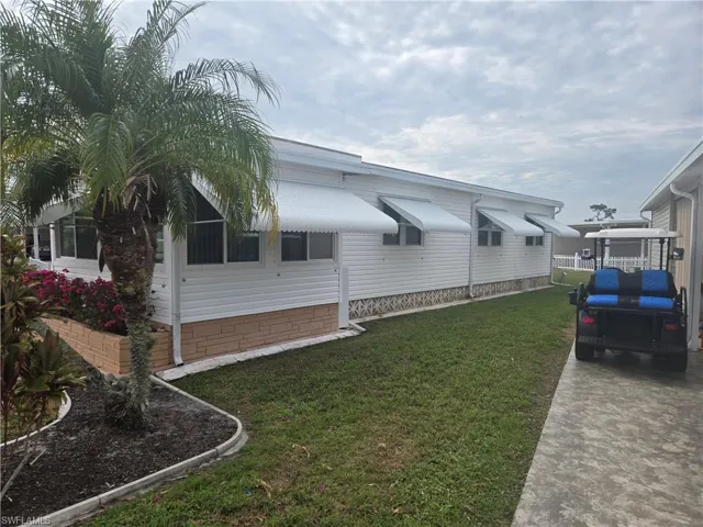 View of property exterior featuring a yard