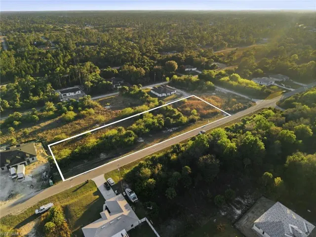 Aerial view of property's location featuring a forest and property parcel outlined