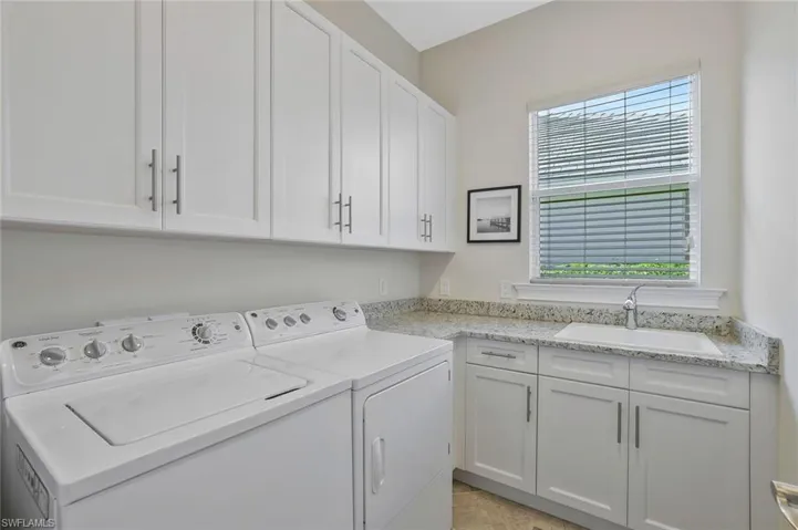 Great Sized Laundry Room with sink and loads of Cabs