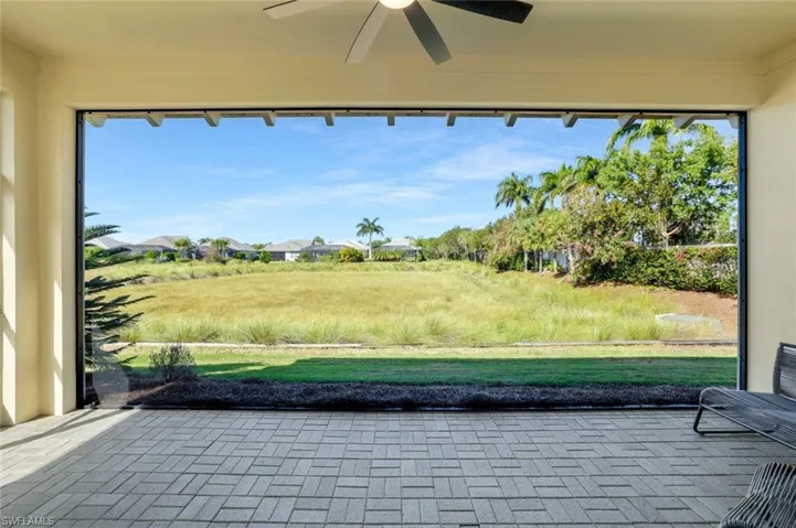 Secondary Lanai/Screened Porch over looks the Very Private Marsh of Long-tailed Grass blowing in the wind