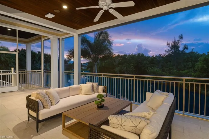 Patio terrace at dusk with outdoor lounge area and ceiling fan