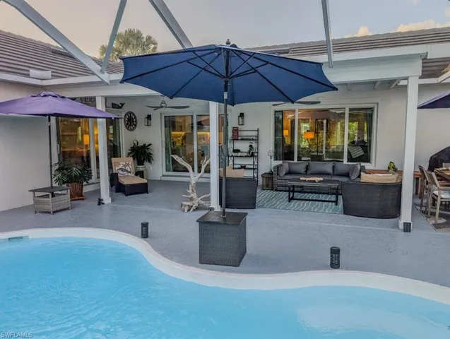 Outdoor pool featuring an outdoor hangout area, glass enclosure, ceiling fan, and a patio area