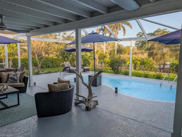 Pool with a lanai and a patio area
