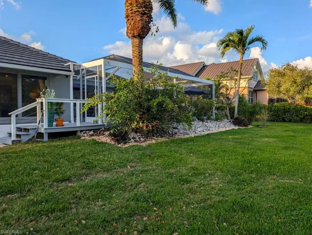 View of yard with glass enclosure