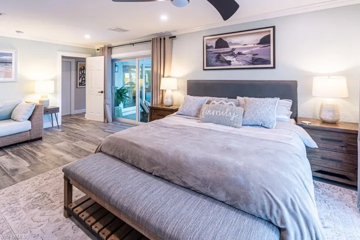 Bedroom with recessed lighting, ornamental molding, access to outside, visible vents, and wood finished floors
