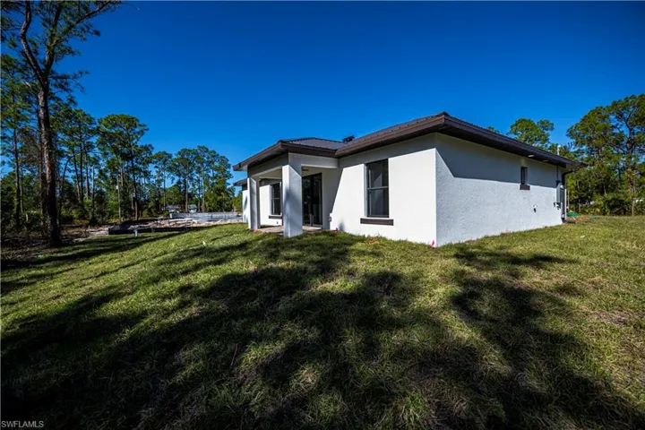 View of side of home with a lawn