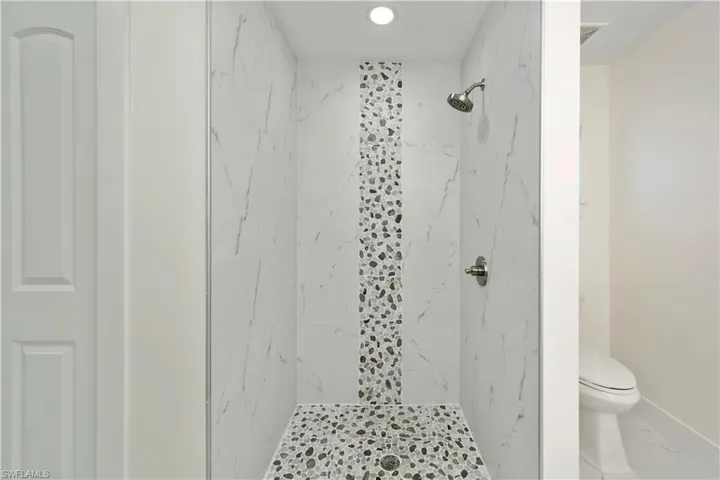 Bathroom with a tile shower and toilet