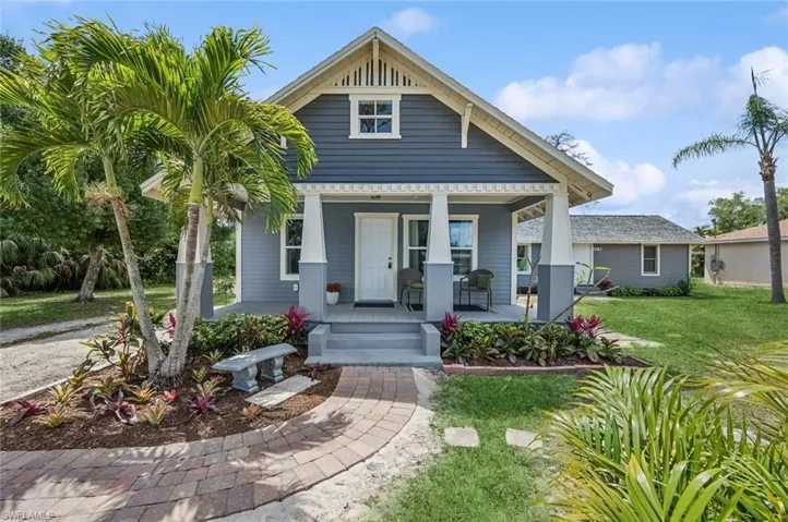 Bungalow with a porch and a front lawn