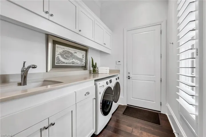 Even the laundry room has quartzite counter, abundant storage, deep sink, and espresso wood flooring.