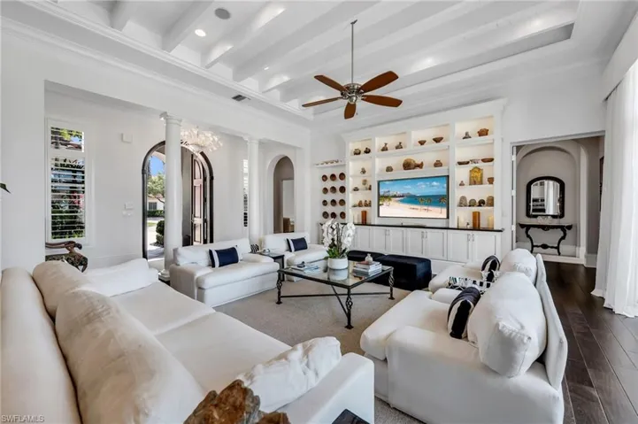 Fabulous great room with unique ceiling details, espresso wood flooring, and bespoke built-ins.
