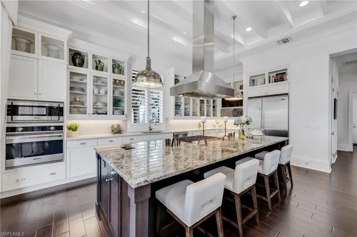 Thoughtful details for the culinary enthusiast, including integrated knife storage and a discreet countertop chute.
