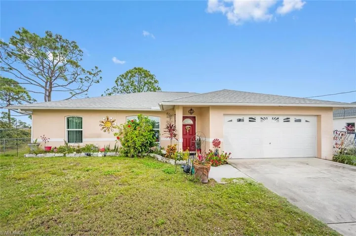 Ranch-style home with a garage and a front yard