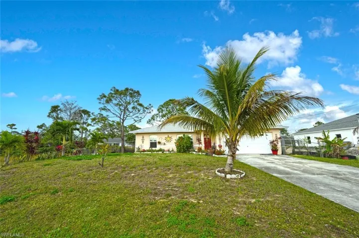 View of front of house with a front yard and a garage