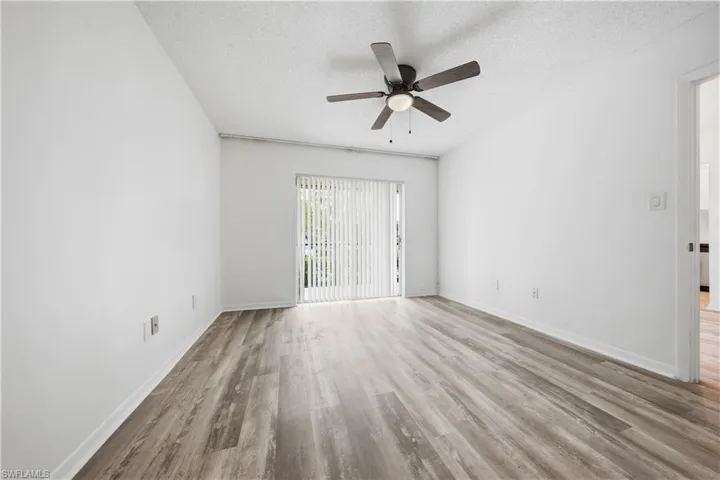 Spare room with light wood-style flooring, a textured ceiling, and a ceiling fan