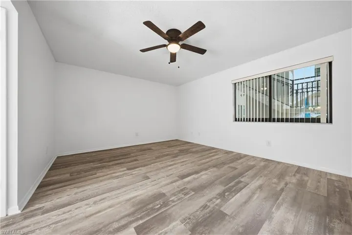 Spare room with ceiling fan and light wood-type flooring