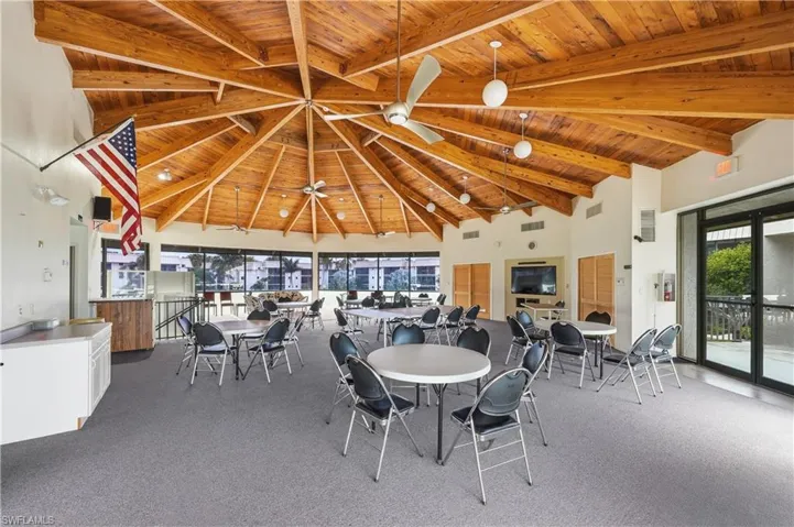 Dining area with a high wooden beamed ceiling and carpet flooring