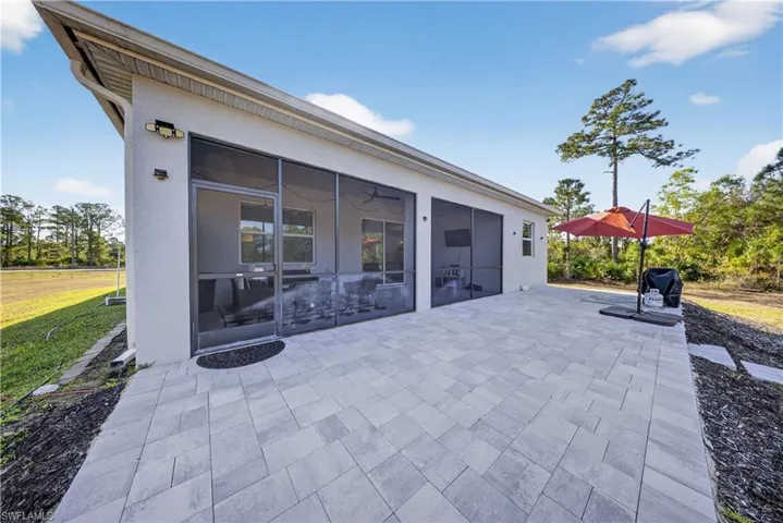 View of patio with a sunroom