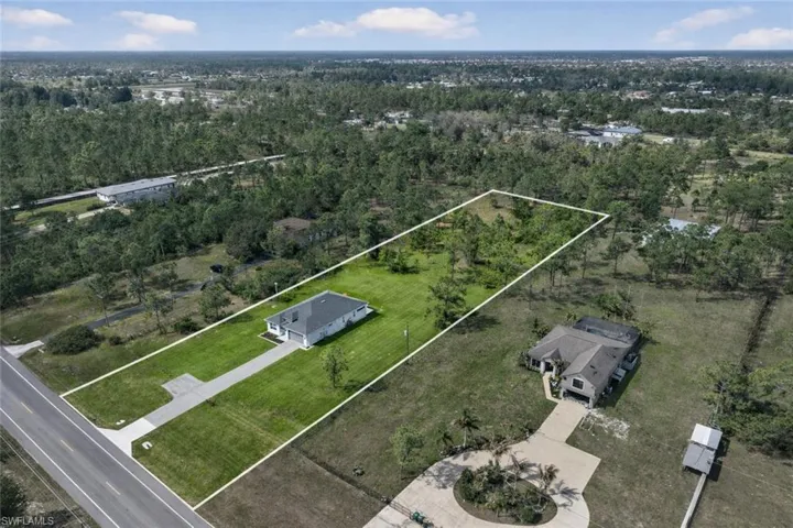 Aerial overview of property's location featuring property boundaries highlighted and a heavily wooded area