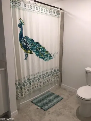 Bathroom with tile patterned floors and toilet