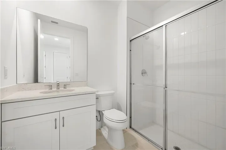 Guest bathroom with full-length shower and beautiful shower floor and wall tile