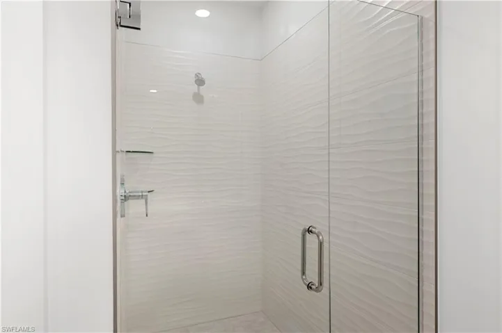 Luxe, walk-in shower with gorgeous shower floor and wall tile