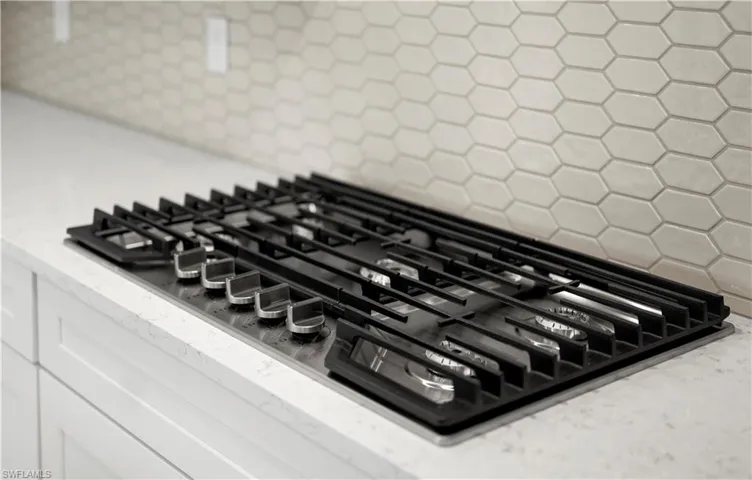Gas cooktop on top of gorgeous quartz countertops