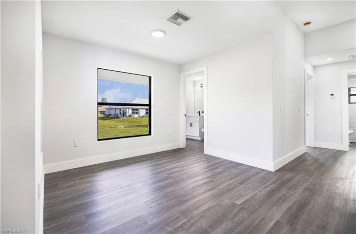 Unfurnished room featuring dark wood-type flooring