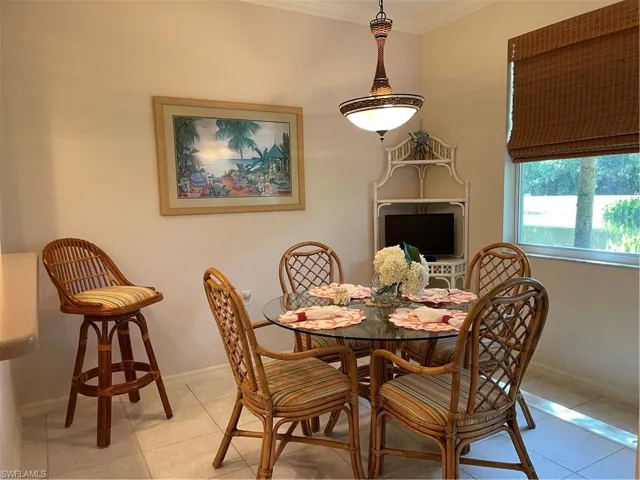 Tiled dining area with crown molding