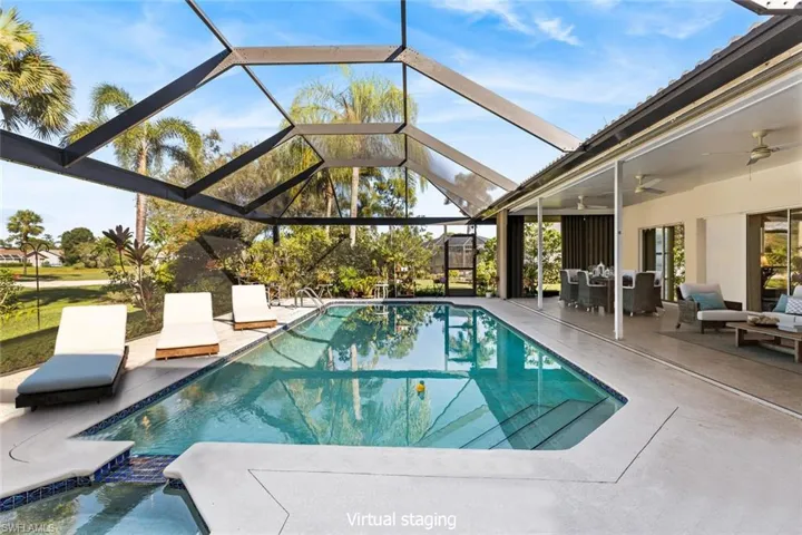 Staged view of swimming pool & sliding doors.  Covered patio with shutters ensures year around entertainment.
