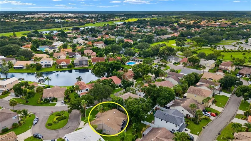 Aerial perspective of suburban area featuring a large body of water