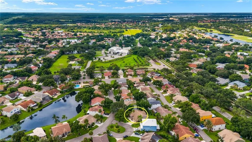 Aerial view of residential area featuring a nearby body of water