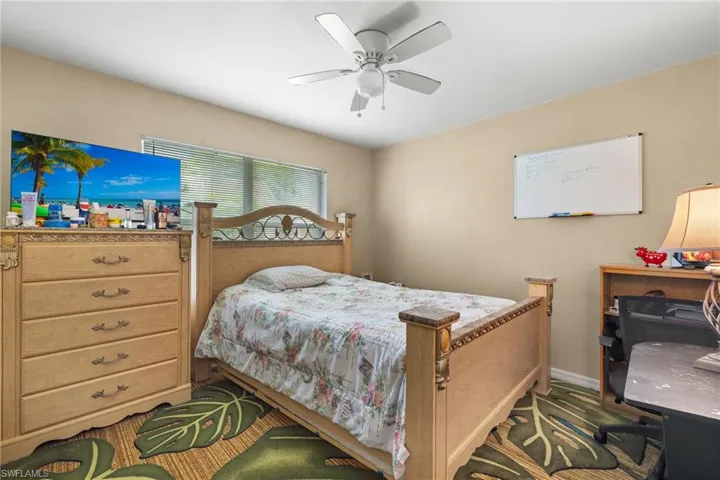 Bedroom with ceiling fan and baseboards