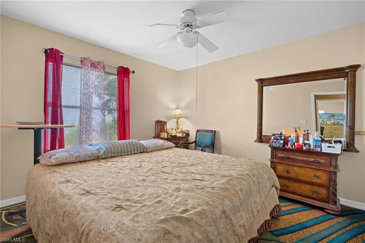 Bedroom featuring ceiling fan and carpet floors