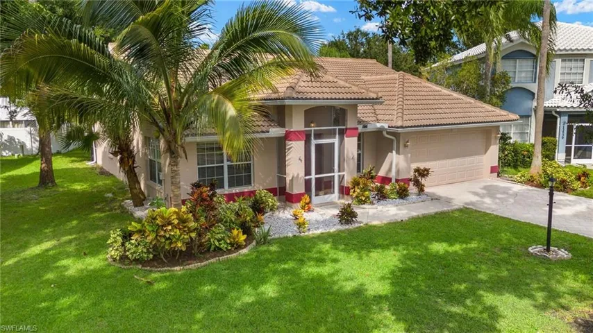 Mediterranean / spanish house featuring stucco siding, concrete driveway, a garage, a front yard, and a tile roof
